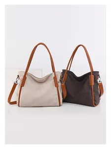 Detail of soft faux leather tote bags with woven accents and adjustable shoulder straps
