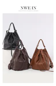 Detailed view of three vintage leather backpacks in black, dark brown and caramel brown