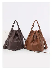 Detail of drawstring bucket bags in pebbled leather with silver hardware and zippers