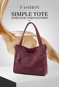 Detail view of burgundy tote bag with pebble leather texture and elegant silk background