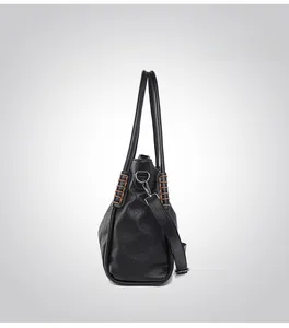 Side view of black faux leather tote featuring brown whipstitch details and adjustable strap