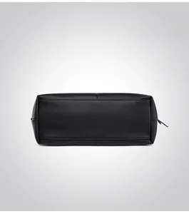 Detailed bottom view of black lychee grain leather tote bag with fine stitching