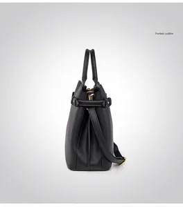 Side view of a black leather bucket handbag showing detailed texture and gold hardware