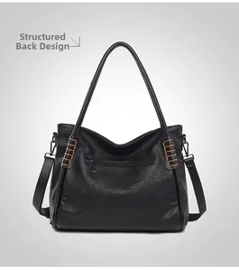 Detail view of the back of a black pebble leather tote bag with functional zipper pocket