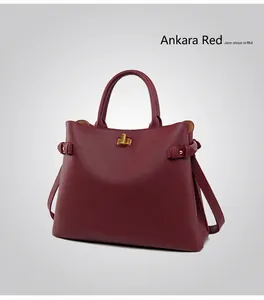 Close-up of Ankola Red leather tote bag with lychee texture and golden twist lock