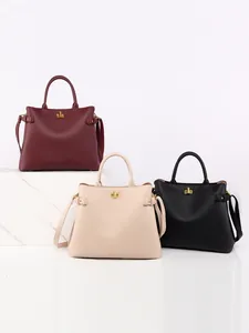 Three elegant leather bucket bags in burgundy, beige and black with gold twist-locks