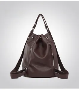 Rear view of brown litchi leather backpack featuring drawstring and adjustable straps