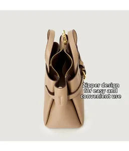 Close-up of beige lychee leather tote bag with metal zipper and spacious interior