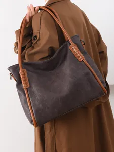 Large brown pebble leather tote bag with contrasting tan straps for daily commute use