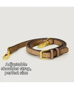 Close-up of adjustable brown litchi pattern leather shoulder strap with gold metal hooks