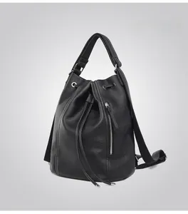 Detail of black pebbled leather backpack with drawstring closure and vertical zipper pocket