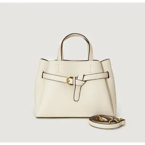 Detail of lychee textured leather tote bag with gold buckle and adjustable strap