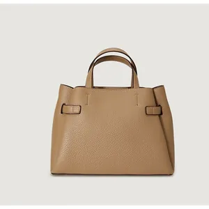 Close-up of light brown lychee grain leather handbag with dual handles and side straps