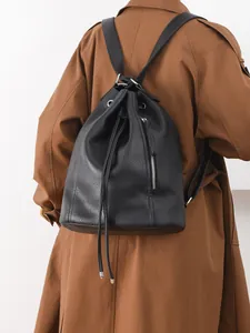 Chic black litchi leather drawstring backpack with silver hardware for women's daily commute
