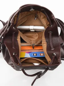 Deep brown leather backpack with large capacity showing organized internal storage