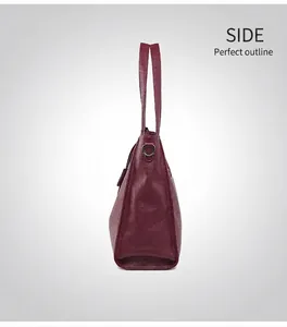 Side view of burgundy litchi-grain leather tote bag with metal D-rings and handles