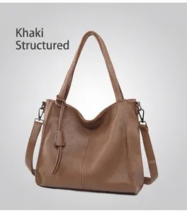 Detailed close-up of dark khaki leather tote showing lychee grain texture and stitching