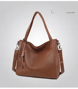 Detailed macro of caramel brown litchi grain leather tote bag with silver hardware