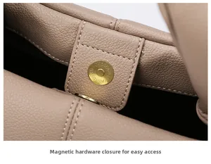 Close-up of golden magnetic closure on lychee pattern faux leather handbag