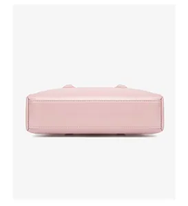 Vista detallada del fondo del bolso de cuero rosa con pies metálicos y costuras finas