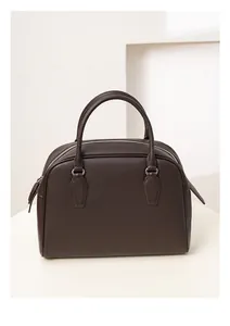 Detailed view of dark brown pebbled leather texture on a stylish Boston tote bag