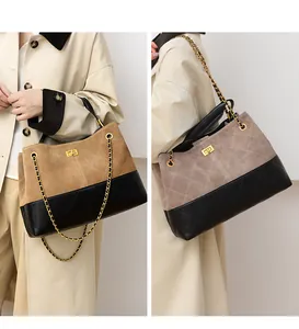 Detail showing contrast quilted leather bucket bag with gold lock and chain strap