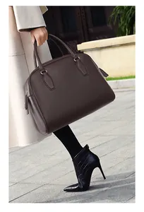 Close-up of deep coffee lychee pattern leather handbag with silver hardware and zipper