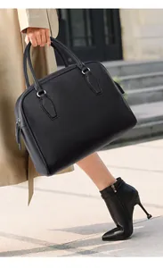 Close-up of black lychee grain leather tote bag with elegant silver hardware details