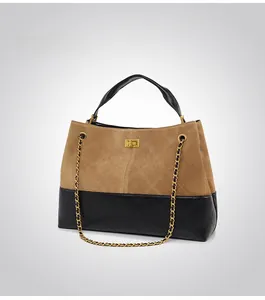Detail of a two-tone frosted tote bag with quilted stitching and gold metal hardware
