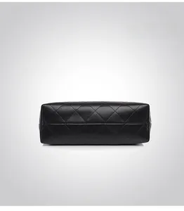 Detailed bottom view of black quilted leather handbag with classic diamond stitch pattern