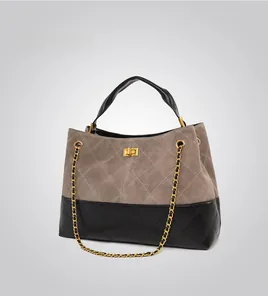 Detail of grey and black quilted tote bag with golden metal twist lock closure