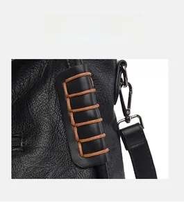 Detail of black leather tote bag featuring contrast brown cord binding decoration