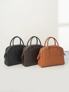 Minimalist pebbled leather tote bags in black and brown, showing a front three-quarter view
