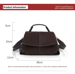 Detail view of brown suede handbag showing dimensions 30x11x19cm and white stitching