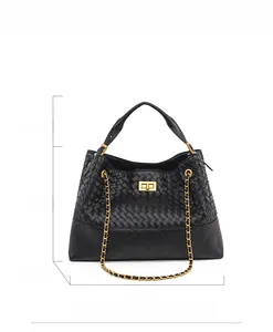 Detail view of woven leather handbag showing 34cm width and 25cm height dimensions