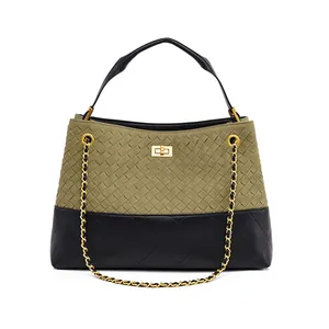 Detail of olive green woven leather and black quilted texture with gold metal lock