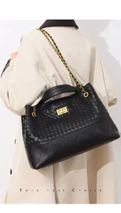 Detail of black woven leather tote featuring diamond quilted base and gold metal twist lock