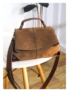 Detail of vintage matte leather tote bag featuring contrast stitching and suede texture