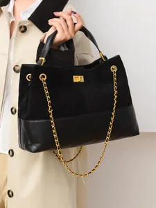 Classic black quilted tote bag with frosted leather finish and golden turn-lock clasp