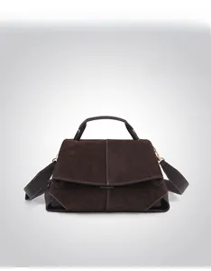 Detail of coffee leather tote bag with white contrast stitching and soft suede texture
