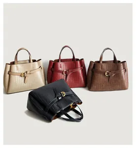 Detail showing woven leather texture and golden horseshoe buckle on stylish tote bags