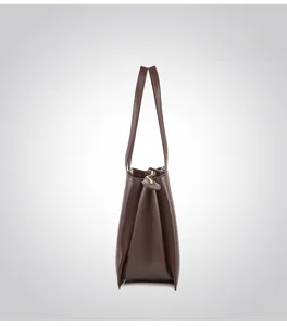 Detail view of structured dark brown leather tote bag with side profile and metal zipper