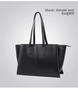 Detail of black pebbled leather tote bag featuring a metallic zipper and vertical stitching