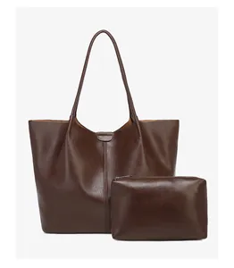 Detailed view of dark brown tote bag set in polished oil wax leather texture