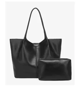 Detailed view of black tote bag set including large shoulder bag and small zipper pouch