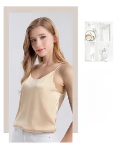 Detail of elegant champagne silk camisole showing smooth satin texture and slim straps