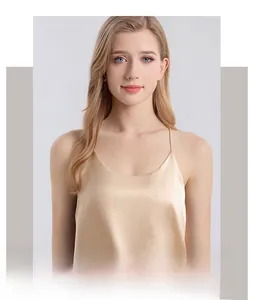 Detail showing elegant champagne silk camisole with thin straps and glossy texture