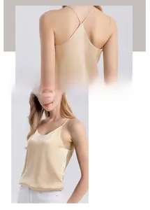 Detail of champagne silk camisole featuring delicate cross straps and satin finish V-neck