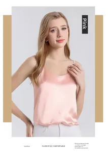 Detail of pink silk satin camisole showing delicate straps and glossy fabric texture