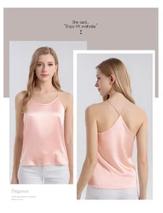 Detail view of pink silk camisole featuring delicate cross-back straps and elegant satin finish
